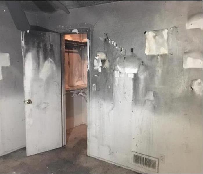 Walls and door of a building covered with smoke