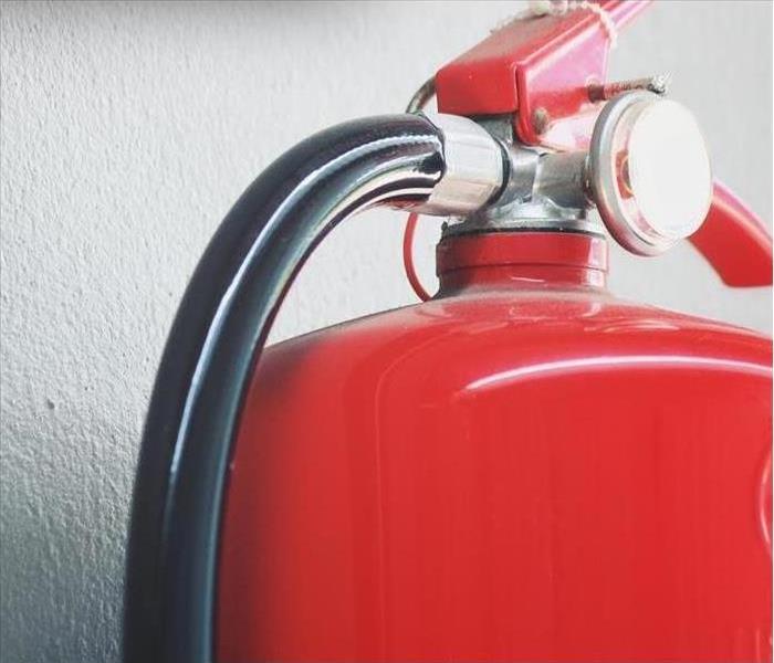 Red tank of fire extinguisher.
